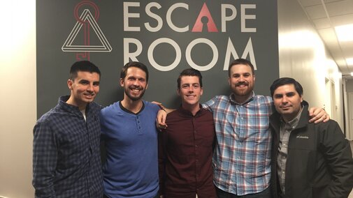 Lab Group Photo in front of escape room sign