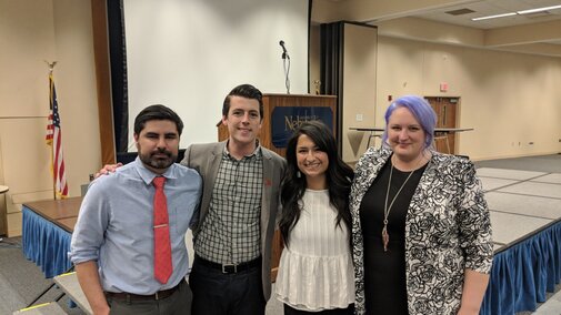 Lab Group Photo at conference speaker podium