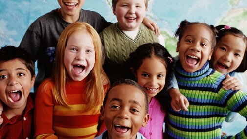 Group of kids smiling at camera.