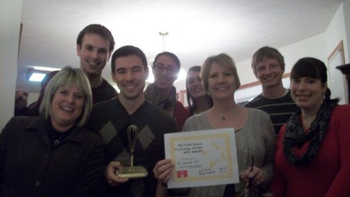 Lab Group Photo holding award